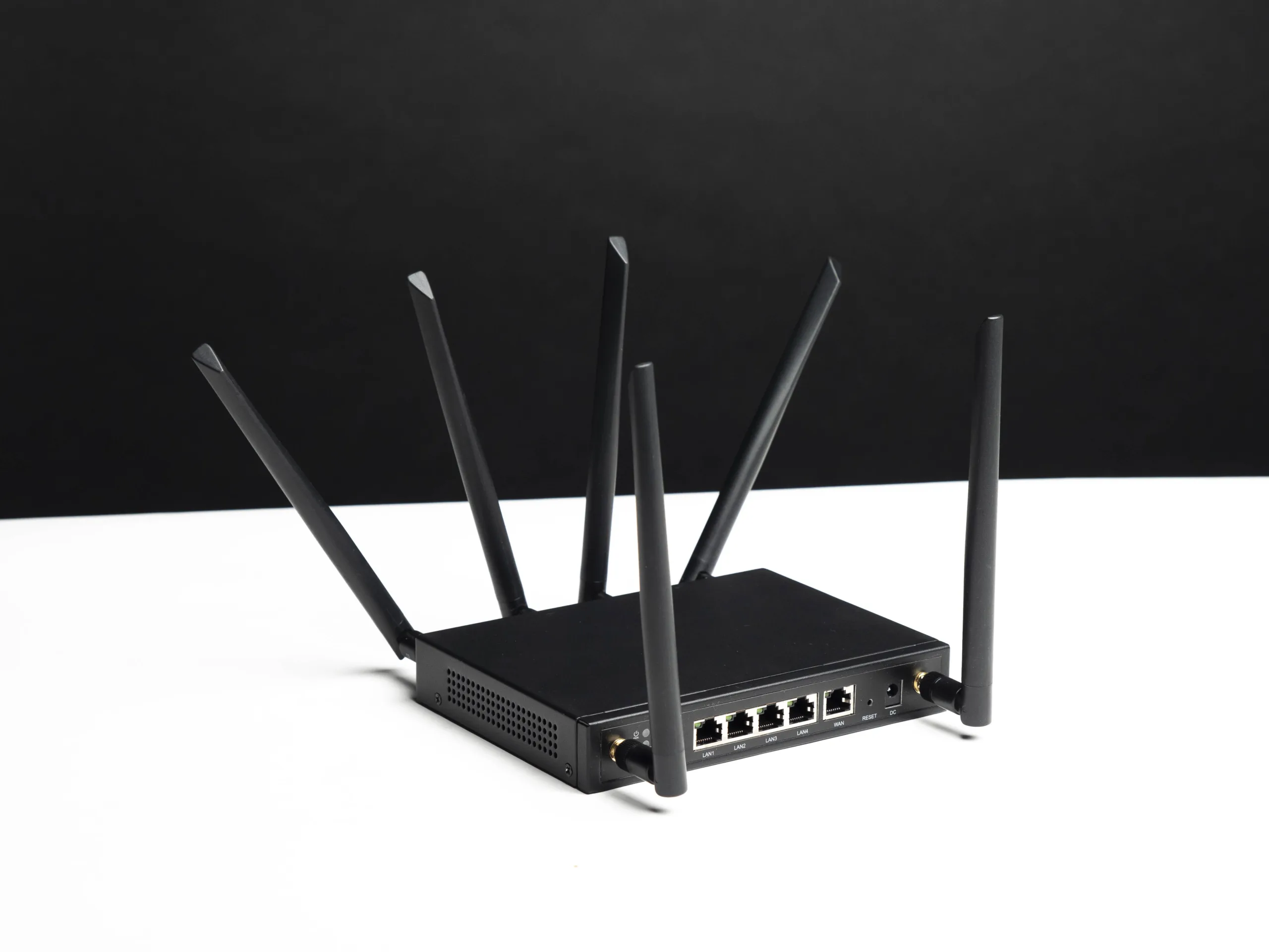 Angled view of the X-LINK router showing its antennas and rear Ethernet ports.