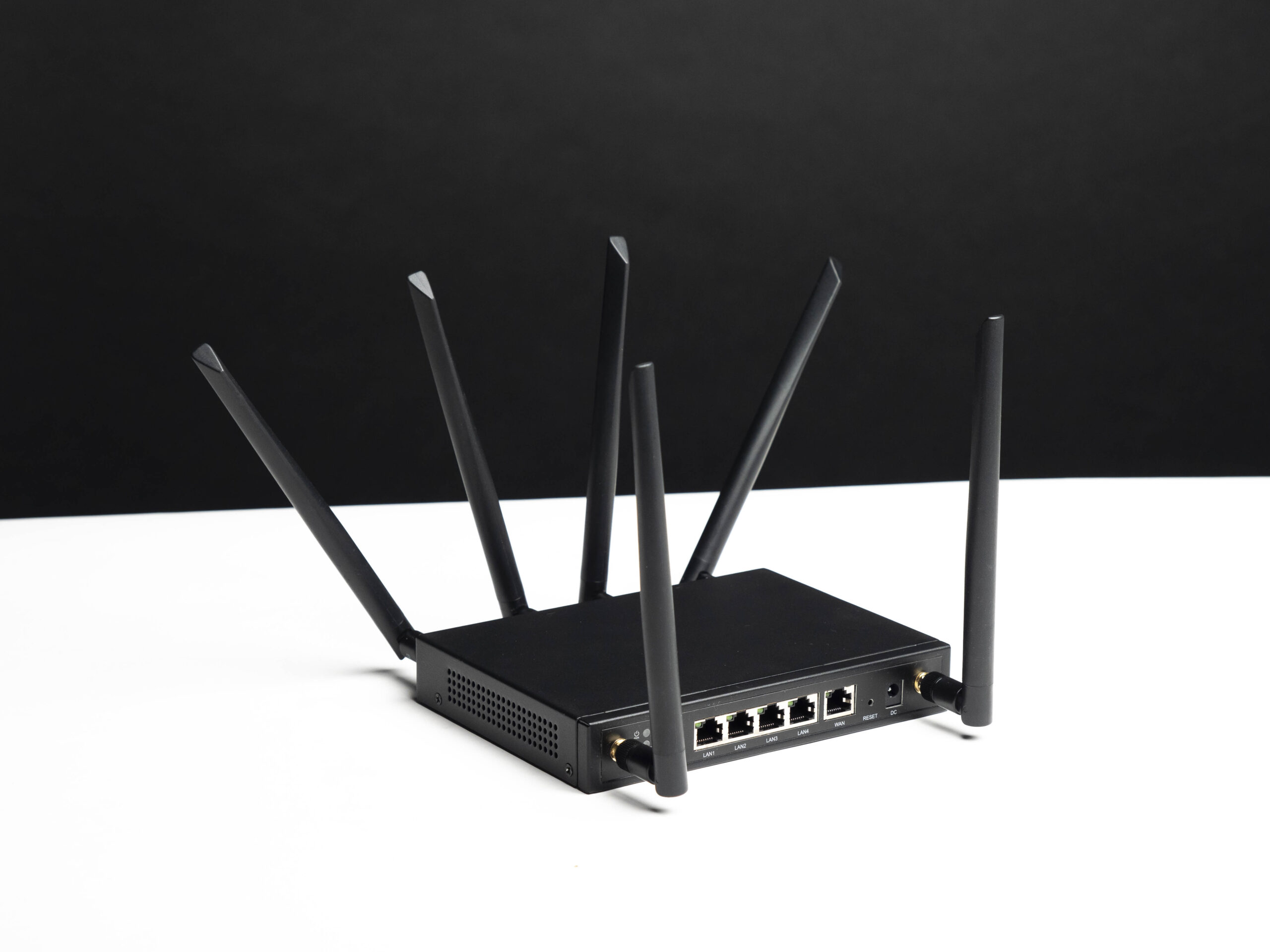 Angled view of the X-LINK router showing its antennas and rear Ethernet ports.
